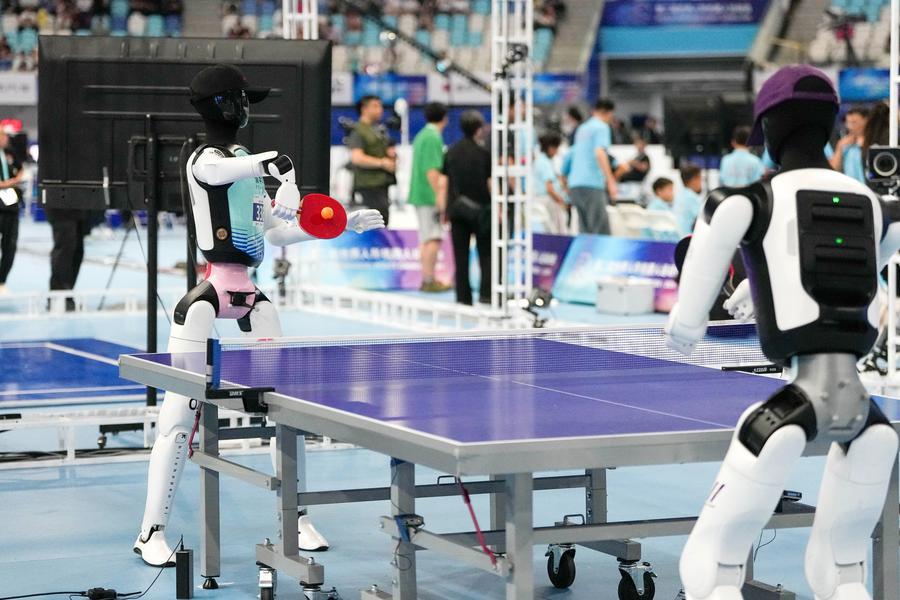 23일 칭화베이런(清華北人) 티로봇(TRobot)팀의 휴머노이드 로봇(왼쪽)이 탁구 경기를 펼치고 있다. (사진/신화통신)