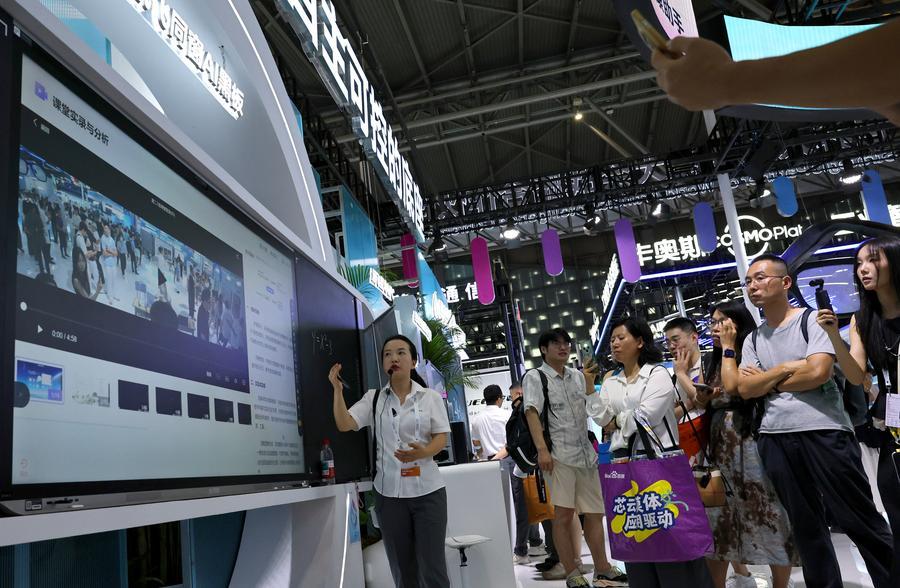 지난달 19일 상하이서 열린 '2026 세계인공지능대회(WAIC)' 커다쉰페이(科大訊飛∙iFLYTEK) 부스에서 직원(왼쪽)이 퉁촹(同窗) AI 칠판 기능을 소개하고 있다. (사진/신화통신)